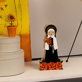 imagem em madeira e acrílico de santa Terezinha sobre aparador moderno